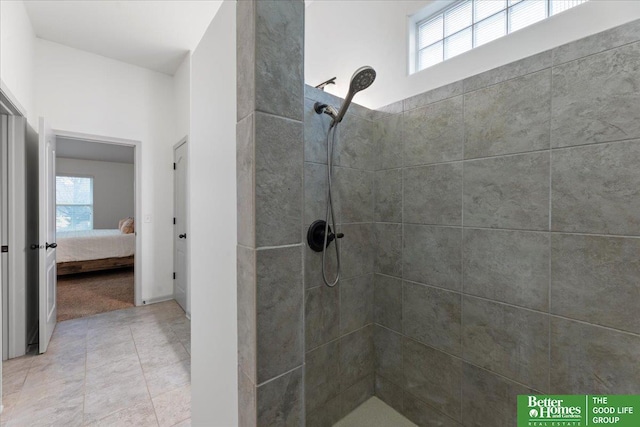 bathroom with connected bathroom, a tile shower, tile patterned floors, and plenty of natural light