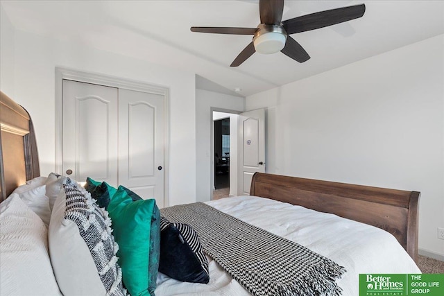 carpeted bedroom featuring vaulted ceiling, baseboards, a closet, and ceiling fan