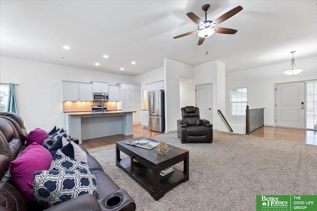 living room featuring a ceiling fan, recessed lighting, and light wood-style floors