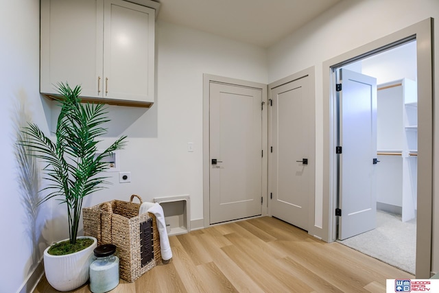 interior space featuring baseboards and light wood-type flooring