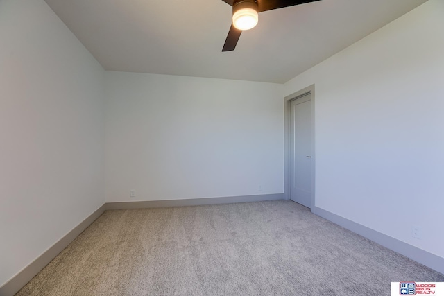 unfurnished room featuring baseboards, light colored carpet, and ceiling fan