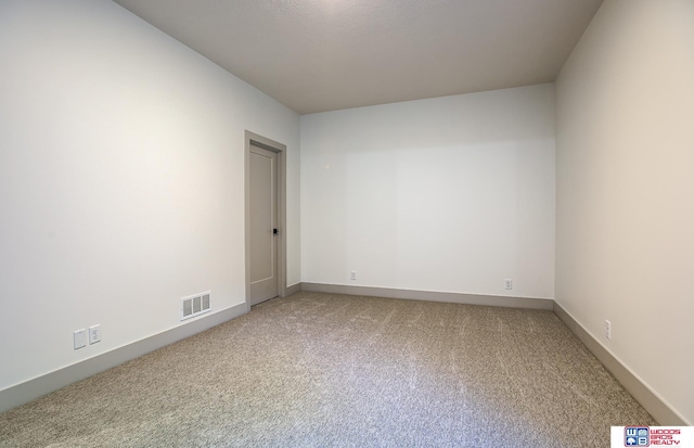 unfurnished room with light colored carpet, baseboards, and visible vents