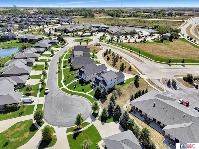 drone / aerial view featuring a water view and a residential view
