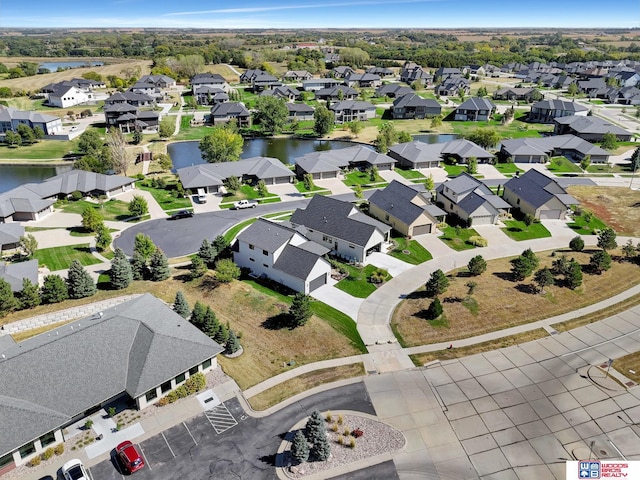 birds eye view of property with a water view and a residential view
