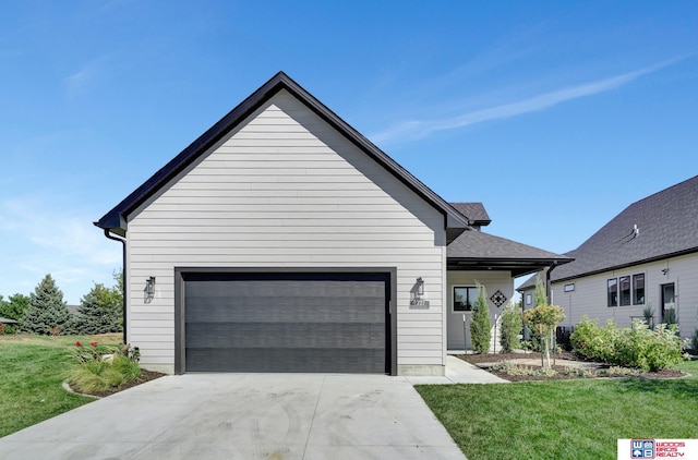 view of front of house featuring a garage, a front yard, and concrete driveway