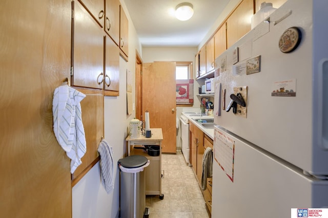 4821-31-41 Colfax Ave, Lincoln, NE 68504 - kitchen featuring freestanding refrigerator, light countertops, light tile patterned flooring, and dishwasher