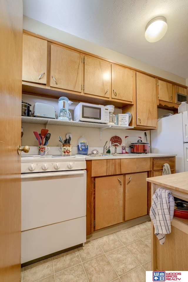 4821-31-41 Colfax Ave, Lincoln, NE 68504 - kitchen with light countertops, light tile patterned flooring, and white appliances
