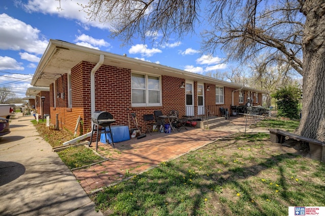 4821-31-41 Colfax Ave, Lincoln, NE 68504 - rear view of house featuring a patio area and brick siding