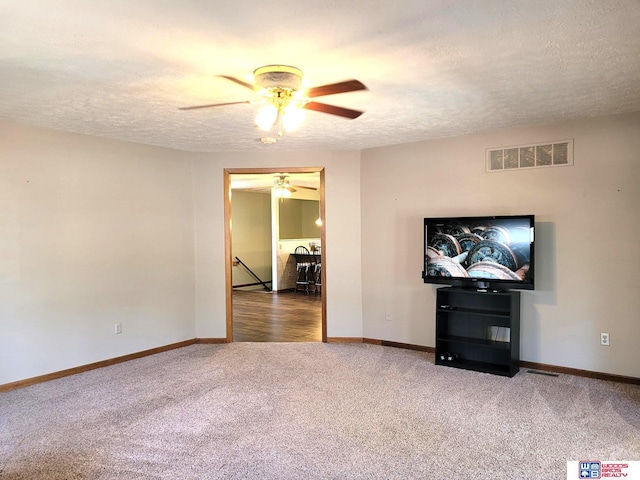 1321 Frances St, Goehner, NE 68364 - unfurnished living room featuring a ceiling fan, a textured ceiling, carpet, baseboards, and visible vents