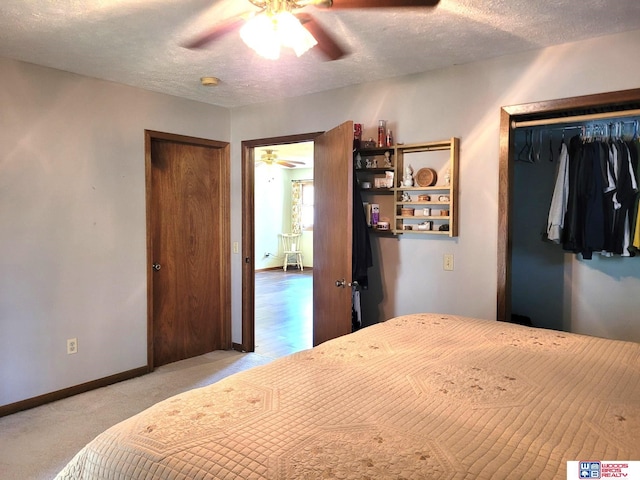 1321 Frances St, Goehner, NE 68364 - carpeted bedroom featuring baseboards, a ceiling fan, a textured ceiling, and a closet