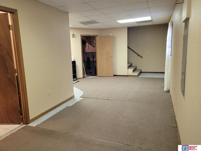 1321 Frances St, Goehner, NE 68364 - below grade area featuring carpet, a drop ceiling, and stairway