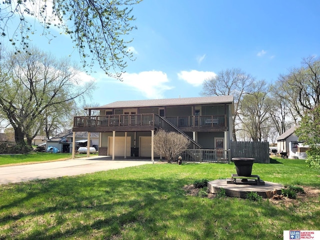 1321 Frances St, Goehner, NE 68364 - back of house with stairway, an attached garage, driveway, and a yard