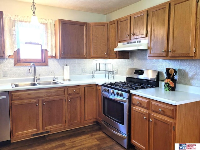 1321 Frances St, Goehner, NE 68364 - kitchen with brown cabinets, under cabinet range hood, stainless steel appliances, light countertops, and a sink