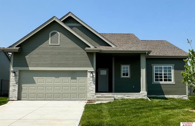 view of front facade featuring a front lawn, driveway, stone siding, and a shingled roof