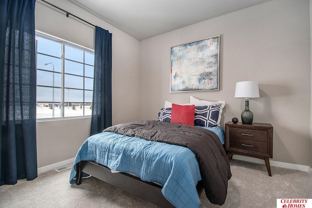 bedroom with carpet floors, visible vents, and baseboards