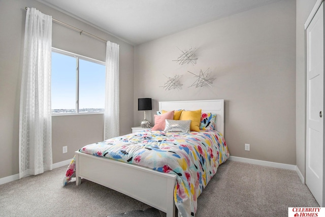 bedroom with carpet and baseboards