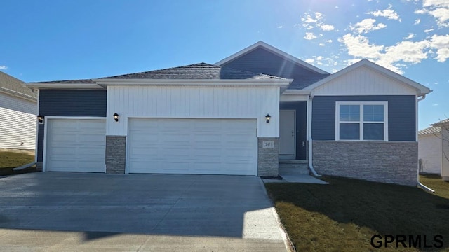 single story home with driveway, stone siding, and a garage