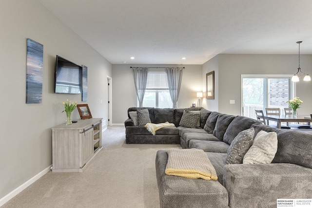 living room with recessed lighting, baseboards, and light colored carpet