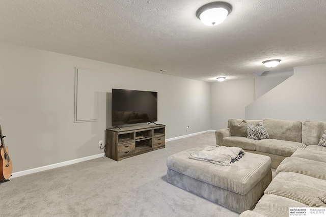 living area with carpet floors, a textured ceiling, and baseboards