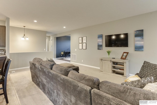 living room with visible vents, light carpet, baseboards, and recessed lighting