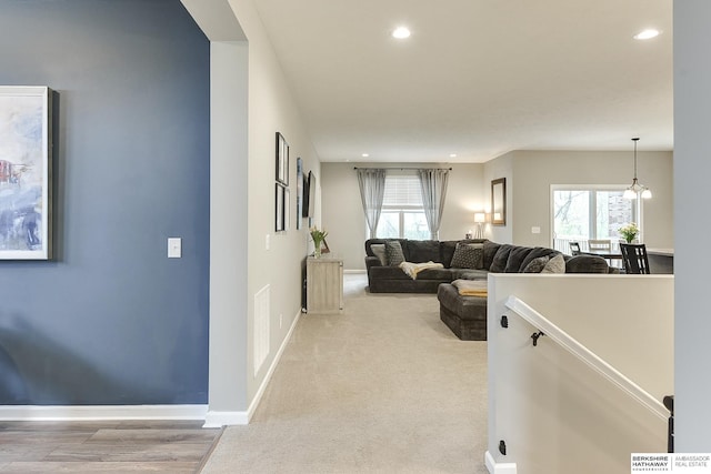 living area with baseboards, a wealth of natural light, and recessed lighting