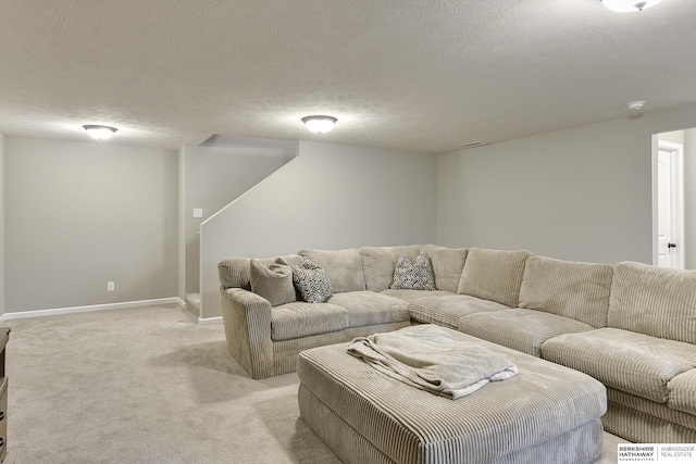 living area featuring a textured ceiling, baseboards, and light carpet