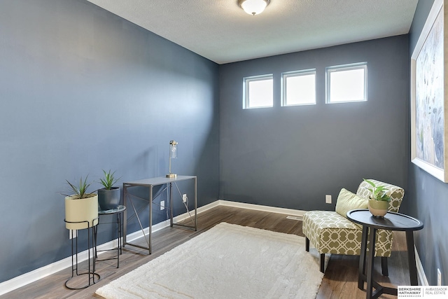 living area with wood finished floors and baseboards