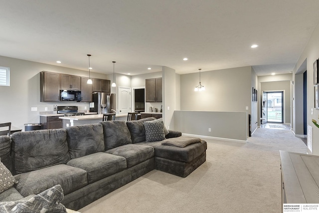 living area featuring light colored carpet, baseboards, a wealth of natural light, and recessed lighting