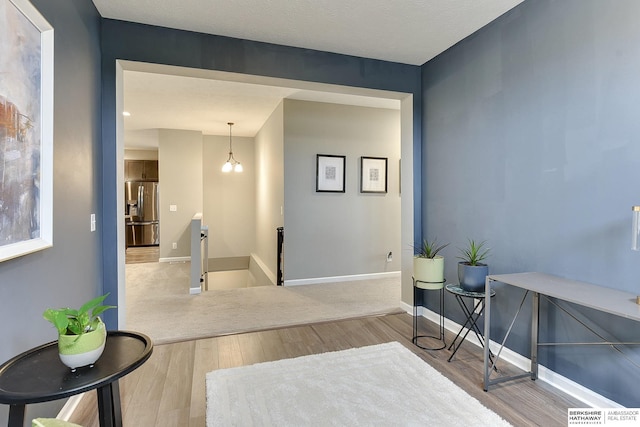 interior space featuring baseboards and wood finished floors