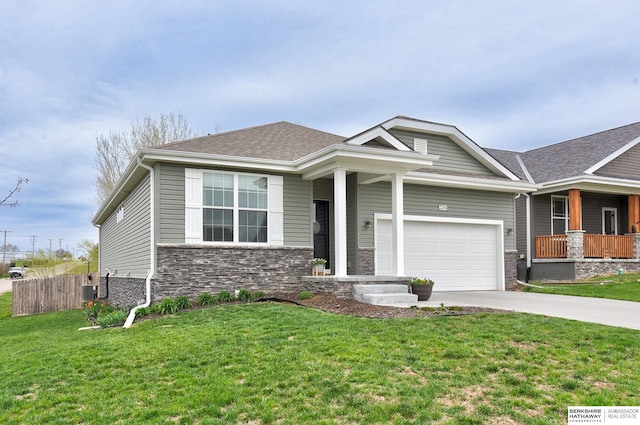 craftsman-style home with central AC, driveway, stone siding, fence, and a front yard