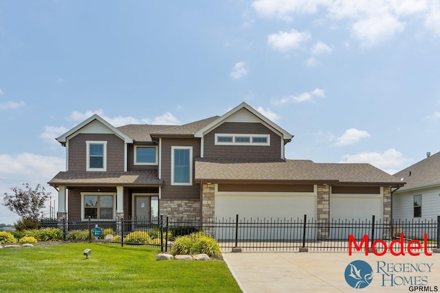 craftsman house featuring a fenced front yard, a front lawn, an attached garage, driveway, and stone siding