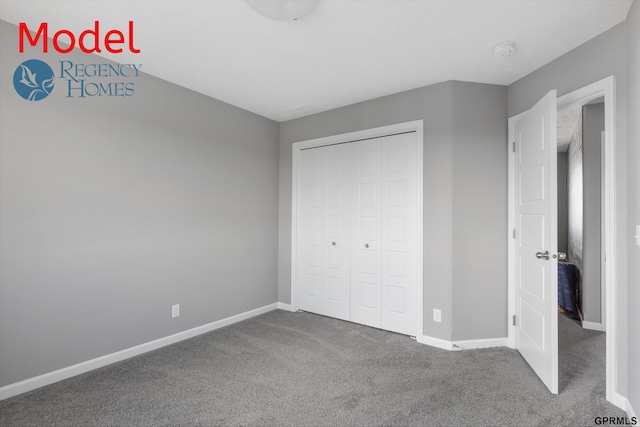 unfurnished bedroom with baseboards, carpet, and a closet