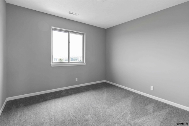 empty room featuring baseboards, carpet flooring, and visible vents
