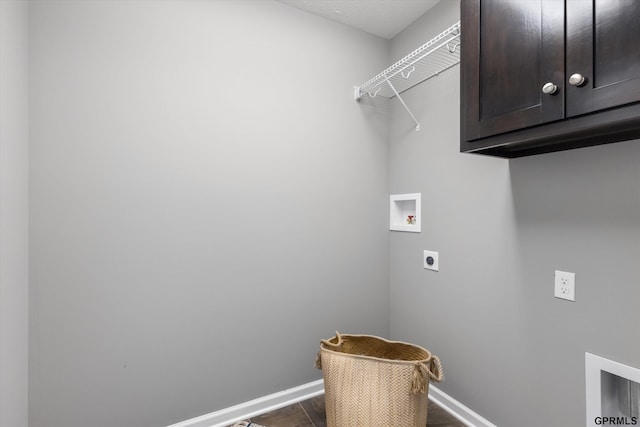 clothes washing area featuring dark wood-style floors, hookup for an electric dryer, baseboards, hookup for a washing machine, and cabinet space