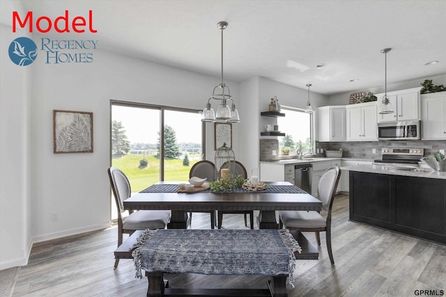 dining room with baseboards, light wood-style floors, and recessed lighting