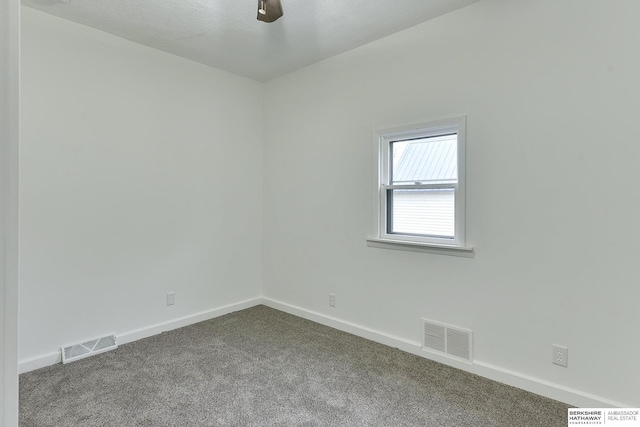 912 Hill St, Harlan, IA 51537 - carpeted spare room with baseboards and visible vents