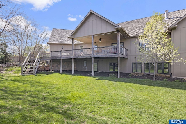 back of house with a lawn, stairs, and a deck
