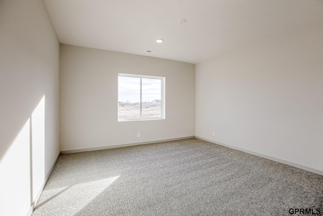 empty room with baseboards, carpet floors, and recessed lighting