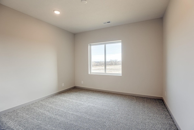 unfurnished room with recessed lighting, baseboards, visible vents, and light colored carpet