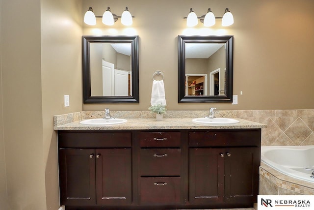 9441 Southern Sky Cir, Lincoln, NE 68505 - bathroom with tiled tub, a sink, and double vanity