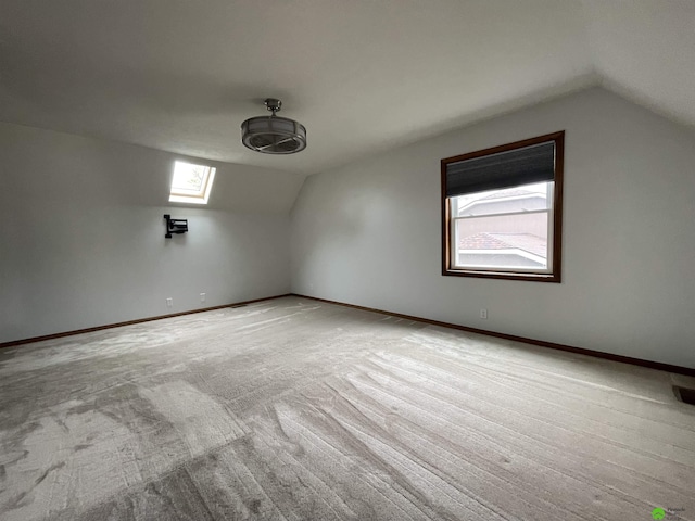 additional living space with vaulted ceiling, carpet, and baseboards