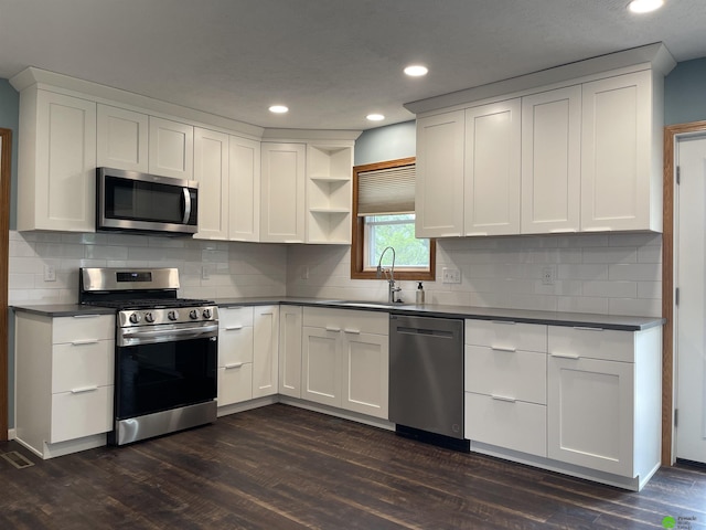 kitchen with recessed lighting, white cabinetry, stainless steel appliances, open shelves, and dark wood-style floors