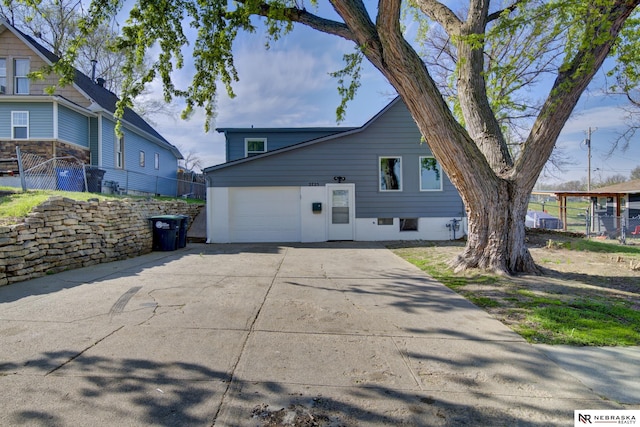 2725 Monroe St, Omaha, NE 68107 - view of side of home with an attached garage, driveway, and fence