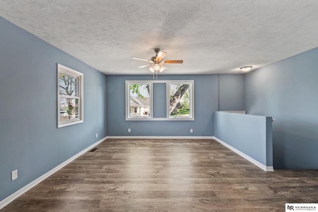 2725 Monroe St, Omaha, NE 68107 - empty room featuring wood finished floors, a textured ceiling, baseboards, and ceiling fan