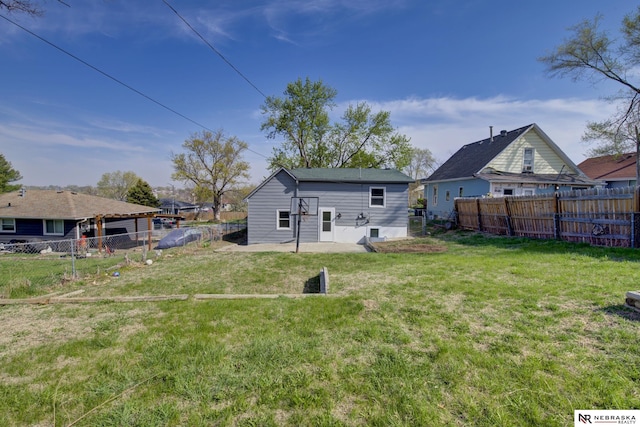 2725 Monroe St, Omaha, NE 68107 - back of house with a lawn and a fenced backyard