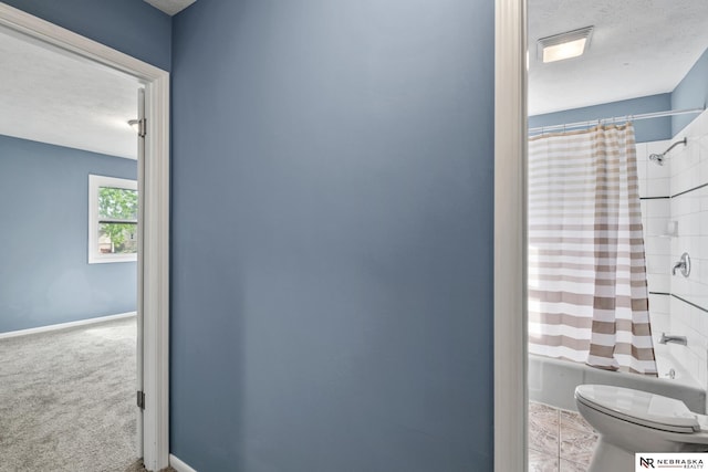 2725 Monroe St, Omaha, NE 68107 - full bathroom with toilet, shower / tub combo with curtain, a textured ceiling, and baseboards