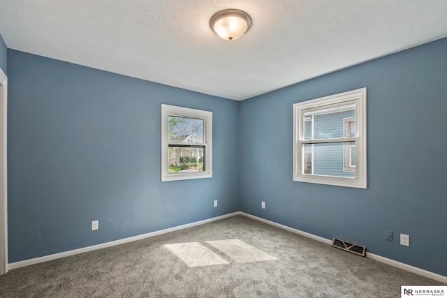 2725 Monroe St, Omaha, NE 68107 - carpeted empty room with a textured ceiling, visible vents, and baseboards