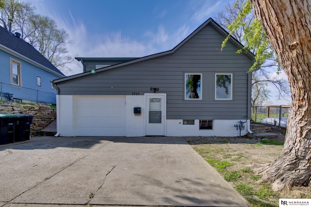 2725 Monroe St, Omaha, NE 68107 - view of front of property with an attached garage and concrete driveway