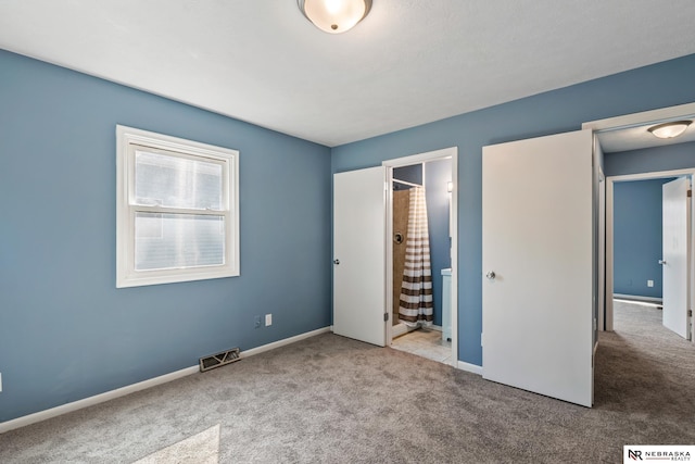2725 Monroe St, Omaha, NE 68107 - unfurnished bedroom with carpet, visible vents, baseboards, and connected bathroom
