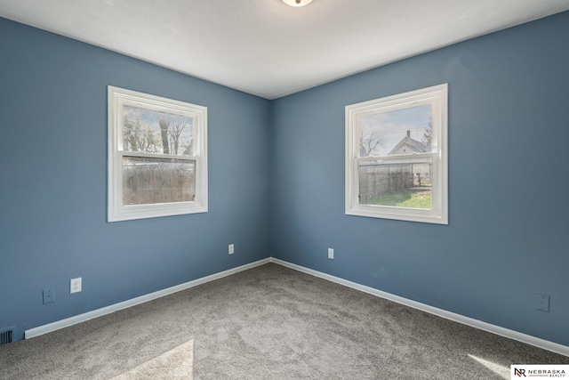 2725 Monroe St, Omaha, NE 68107 - spare room featuring carpet flooring and baseboards